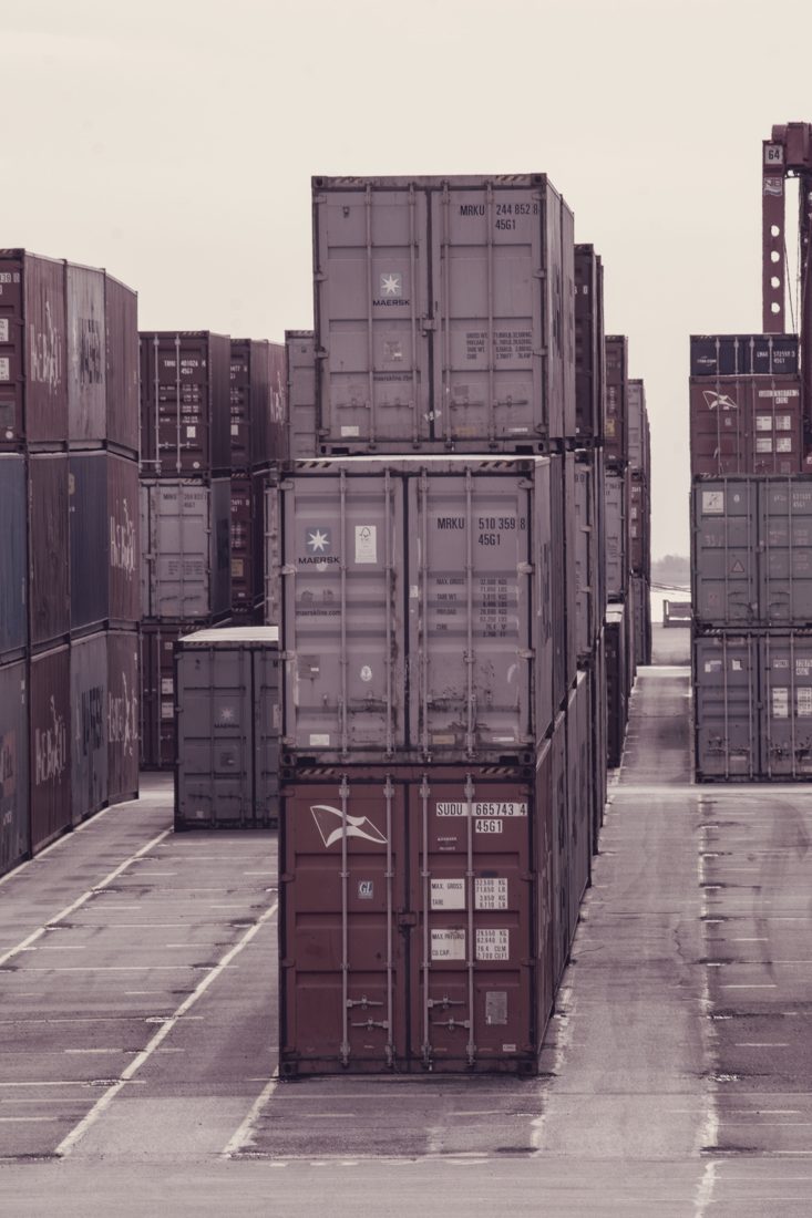 Stacks of sea containers — fashion lots travel as general cargo or in a full container